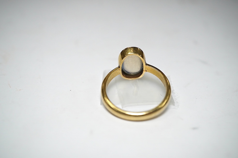 A 14k and single stone cabochon moonstone set ring, size R, gross weight 5.4 grams. Condition - poor to fair